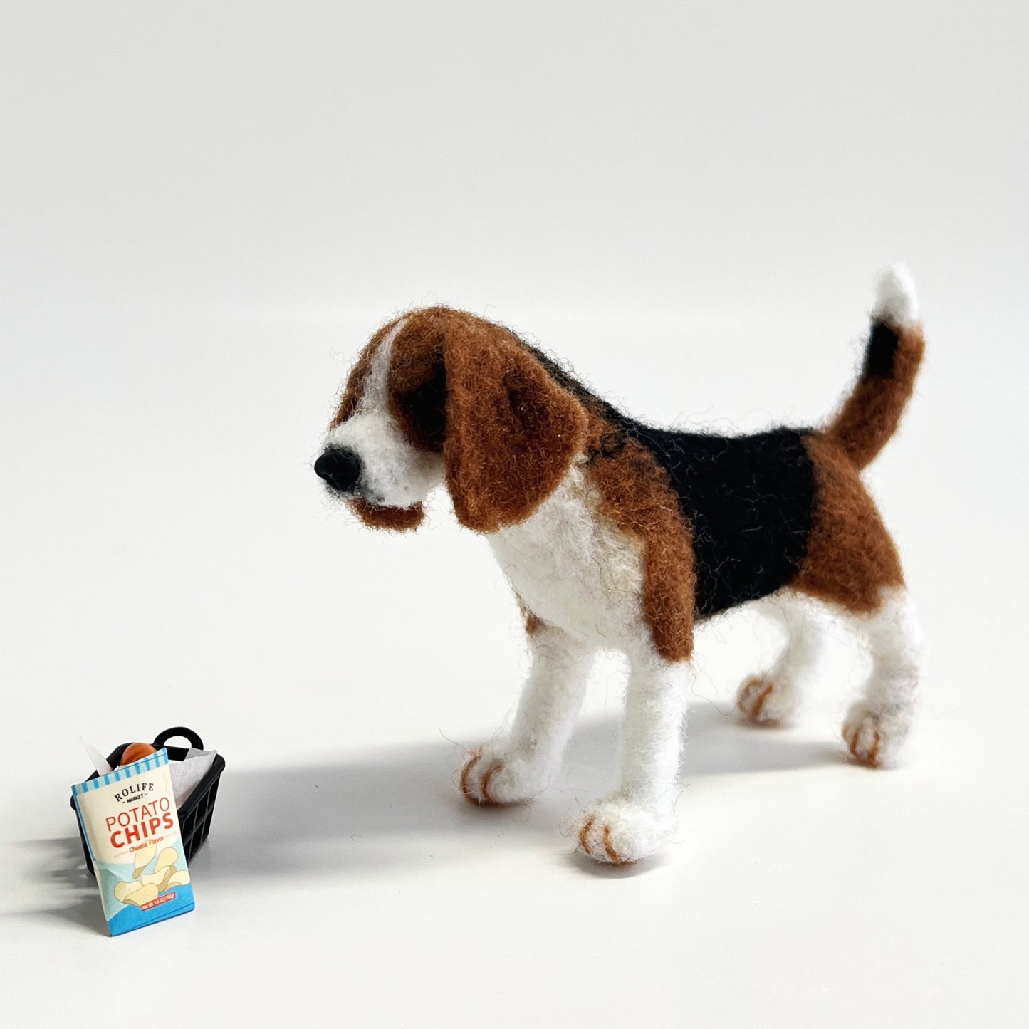 Miniature needle felted Beagle stand with potato chips_front view