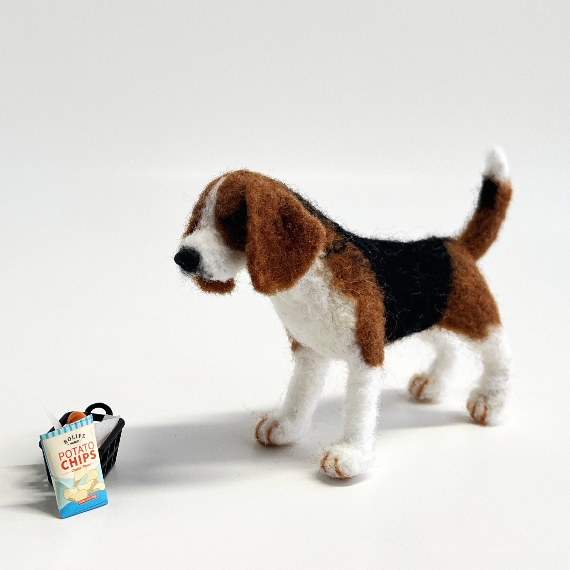 Miniature needle felted Beagle stand with potato chips_front view